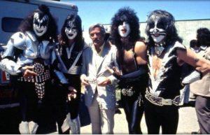 The members of Kiss, in full makeup, flank Stan Lee.